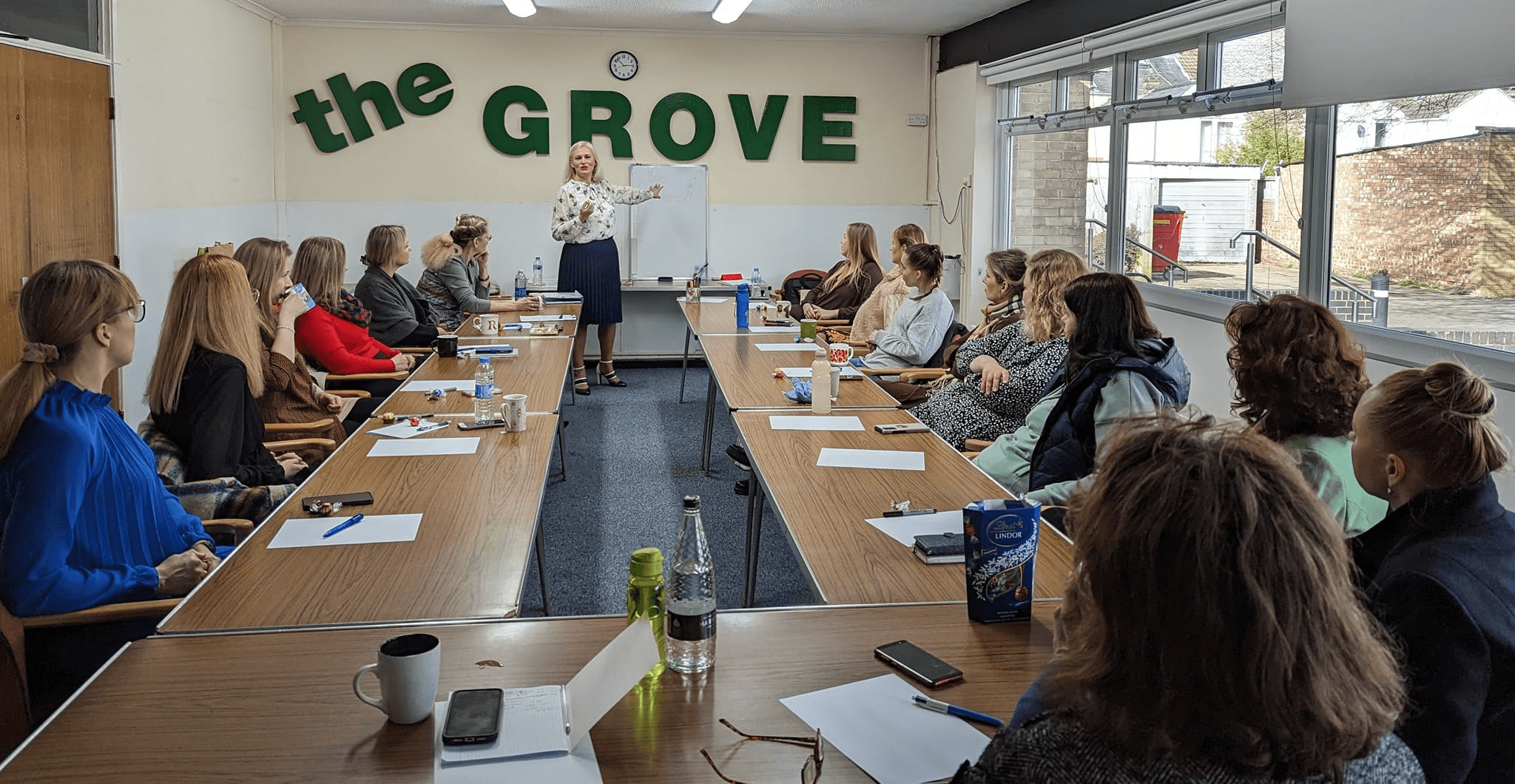Vaida V. Stone speaking to a room of women at a women's empowerment event, ‘The Grove’.